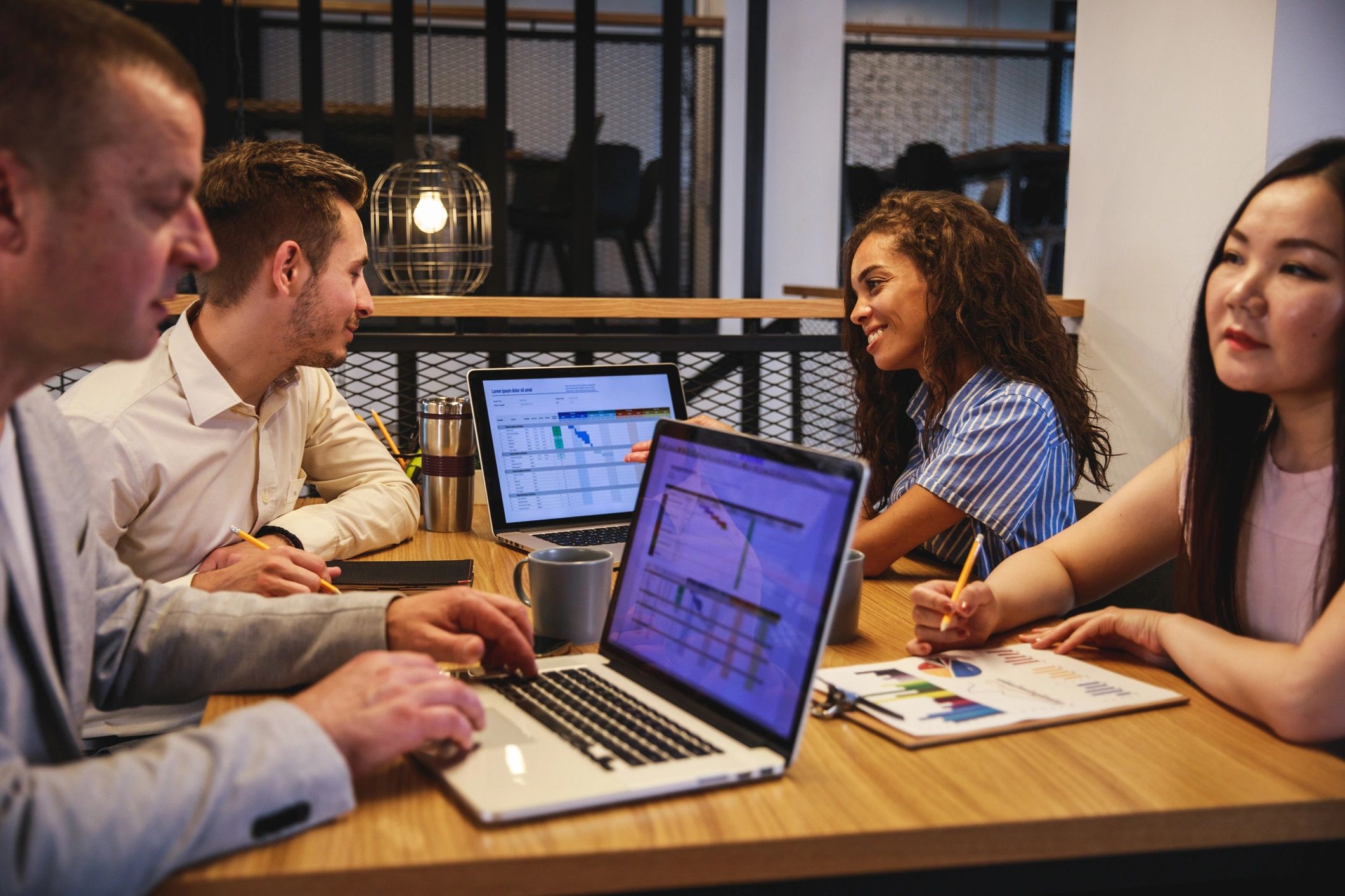 Business partners meeting in a board room reviewing project details
